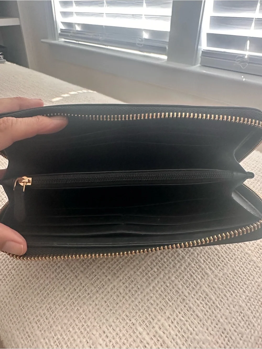 kate spade black Saffiano zip-around wallet with gold logo